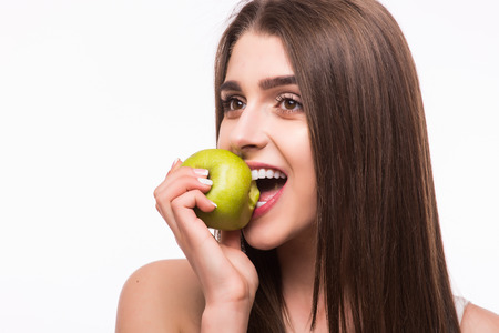 Young girl  eat apple. Female teeth  and apple. Healthy eating on white backgroundの写真素材
