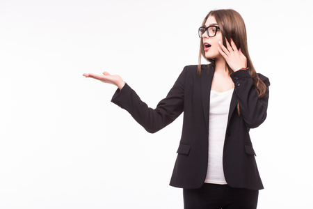 Young elegant business woman pointing invisible product at white backgroundの写真素材