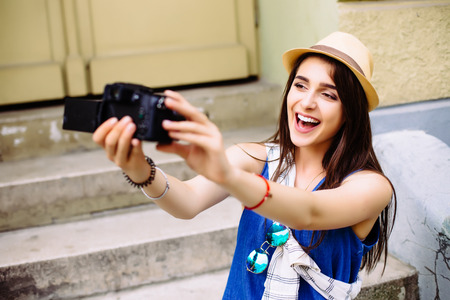 attractive young woman talking pictures outdoorsの写真素材