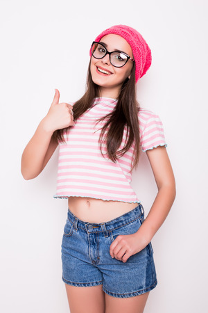 Teen girl with okey gesture on whiteの写真素材