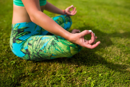 meditation. Yoga girl training outdoors on nature background. Yoga concept.の写真素材