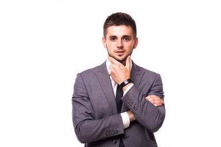 Portrait of a pensive businessman touching his chin over white backgroundの写真素材
