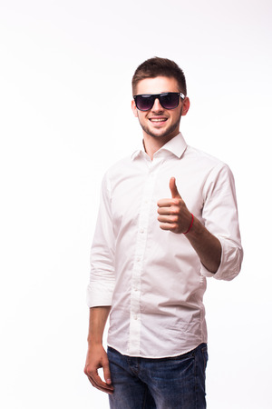 Handsome businessman in sunglasses pointing at camera over white backgroundの写真素材