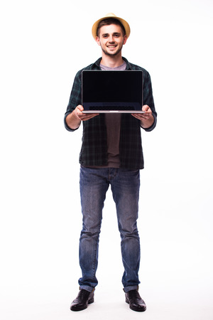 Happy young man holding laptop on white backgroundの写真素材