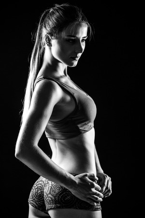 attractive fitness woman, trained female body. Black and white photo.の写真素材