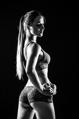 attractive fitness woman, trained female body. Black and white photo.の写真素材