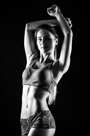 attractive fitness woman, trained female body. Black and white photo.の写真素材