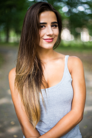 Outdoors portrait in park of a beautiful tanned teen student girl.の写真素材