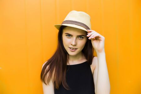 Smiling summer woman with hat and sunglasses over bright background.の写真素材