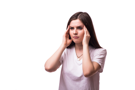 young woman holding her head in pain and discomfortの写真素材