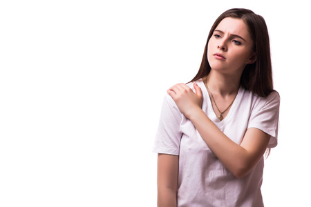 Acute pain in a woman elbow. Female is holding hand to spot of elbow pain indicating location of the pain. Isolation on a white background.の写真素材