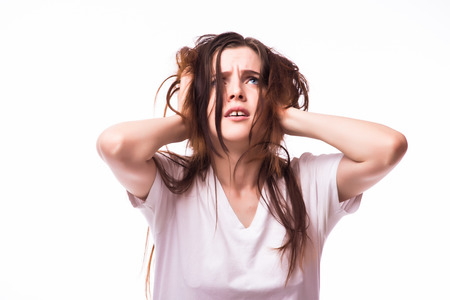 young woman holding her head in pain and discomfortの写真素材