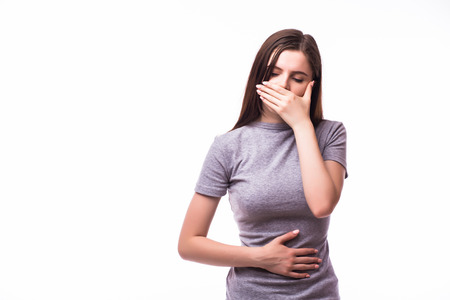 Closeup portrait of young unhappy, annoyed, sick woman about to chuck, throw up, retch barf, hurl isolated on white background.の写真素材