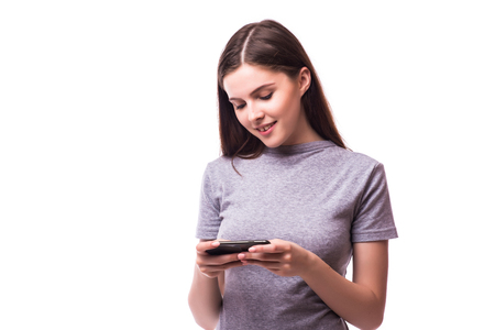 Young Woman Using a mobile Cell Phone Isolated on Whiteの写真素材