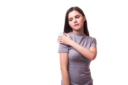 Acute pain in a woman elbow. Female is holding hand to spot of elbow pain indicating location of the pain. Isolation on a white background.の写真素材