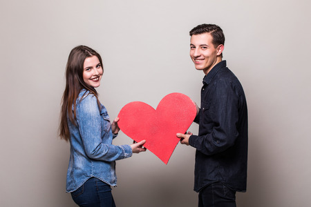 Couple with a red heart on white backgroundの写真素材