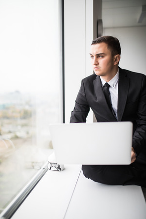 Business man with laptop in the officeの写真素材