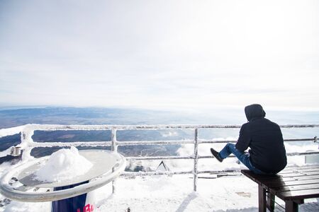 Young man view mountains Winter in High Tatras Mountains. High Tatry. Slovakia. Vysoke Tatry.の写真素材
