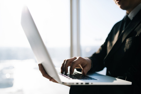 Close up of businessman hand typing on laptopの写真素材