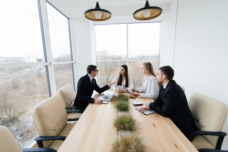 Corporate work. Team listen at meeting leader of project at conference table.