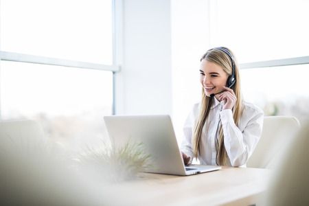 Woman customer support operator with headset and smilingの写真素材
