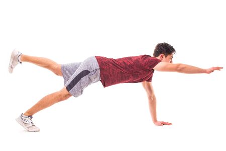 Bird Dog Plank. Young man doing sport exercise.