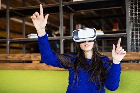 woman using modern virtual reality glasses