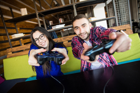 Young man and woman play video games.の写真素材