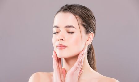 Beautiful Girl face on white. Perfect skinの写真素材