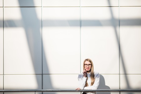 Portrait of blonde business woman in modern office. Office concept.の写真素材