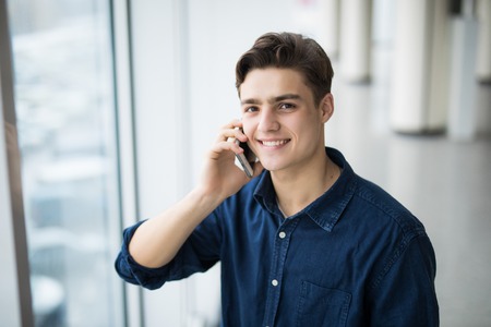 Man talking on the phone in hallの写真素材