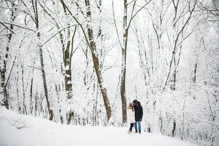 Happy Couple Having Fun Outdoors in Snow Park. Winter Vacation. Couple in park in winterの写真素材