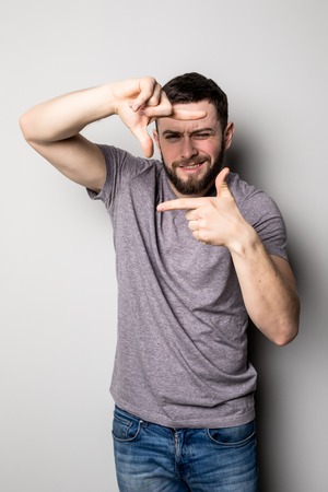 Man framing like photograph over gray background