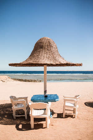 Vacation holidays. beach lounge chairs under tent on beach.の写真素材