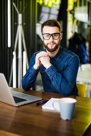 Man working at laptop in contemporary officeの写真素材