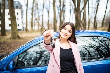 Beautiful young girl with car key in handの写真素材