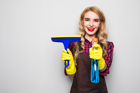 portrait of Attractive young woman cleaning windows.の写真素材