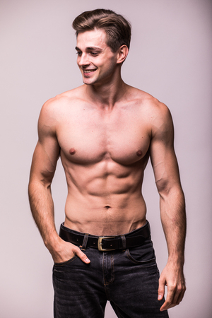 Healthy muscular young man on a gray backgroundの写真素材