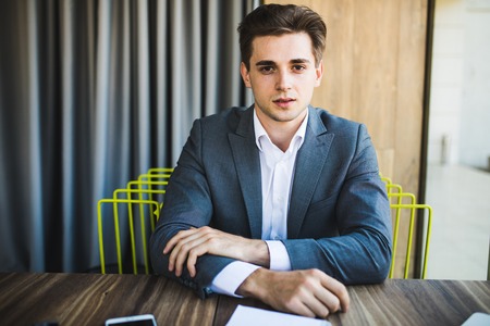 happy young business man portrait in bright modern office