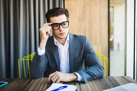 Portrait of young minded man thinking about taskの写真素材