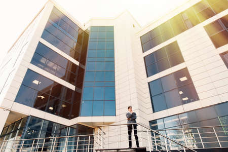 A handsome young business man at office buildingの写真素材
