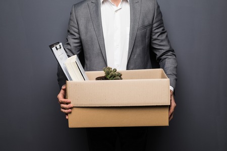 Portrait Of A Young Businessman Carrying Box At His Workplaceの写真素材