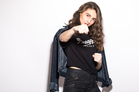 Girl giving punch over isolated white backgroundの写真素材