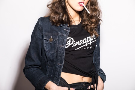 Style woman cool modern clothes with cigarette on white