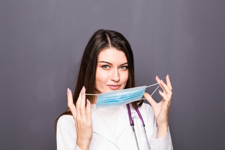 Portrait of Beautiful smiling female Surgeon wearing Mask