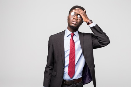 Depressed Business man having an headache on greyの写真素材