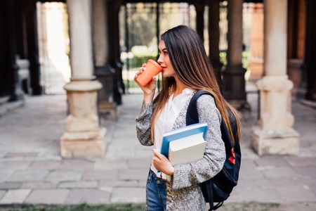 Smart intelligent grad student glasses confident happy at university hall walking to class