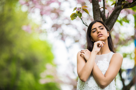 Girl with sakura tree flowers Spring conceptの写真素材