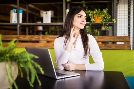 pretty young businesswoman using computer in office