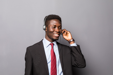 Closeup portrait of a young male customer service representative or call centre worker or operator, support staff speaking with head setの写真素材